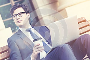 Businessman with coffee and laptop, toned