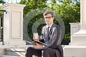 Businessman with coffee and notepad