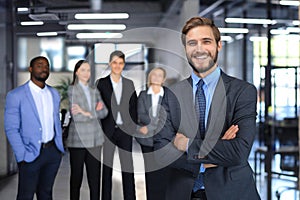 Businessman with colleagues in the background in office