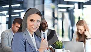 Businessman with colleagues in the background in office