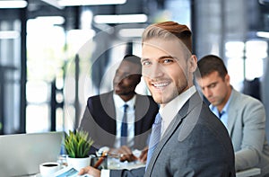 Businessman with colleagues in the background in office