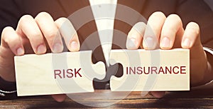 Businessman collects wooden puzzles with the word Risk insurance. The transfer of certain risks to the insurance company. Banking