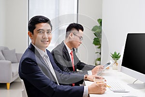 Businessman with collegues smiling