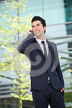 Businessman communicating on mobile phone outdoors photo