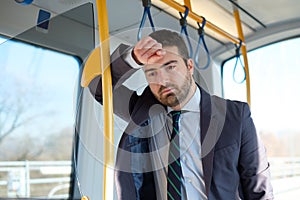 Businessman commuter is traveling and he is sad and tired