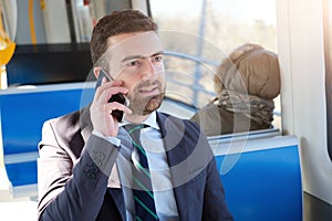 Businessman commuter is traveling and is talking