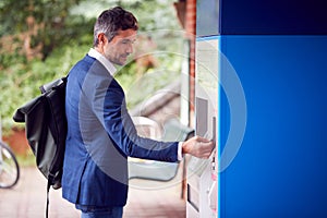 Businessman Commuting Making Contactless Payment For Train Ticket At Station Machine With Card