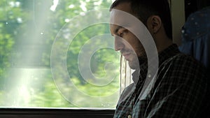 Businessman Commuting On Train Using Digital Tablet.