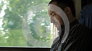 Businessman Commuting On Train Using Digital Tablet.