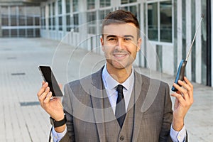 Businessman comparing new and old telephone