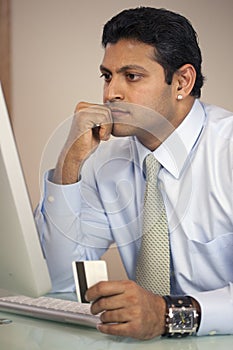 Businessman at computer with credit card