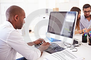 Businessman At Computer In Office Of Start Up Business