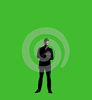 Businessman with computer tablet standing over chroma key background. Business, career job concept.