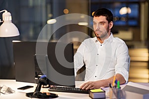 Businessman with computer working at night office