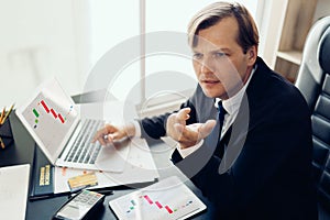 Businessman concentrate and look stress with bad result on laptop  with visual graphic that showing company profit lost in office