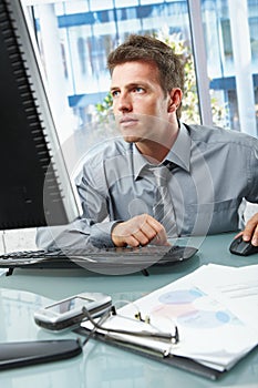 Businessman concentrating on work in office