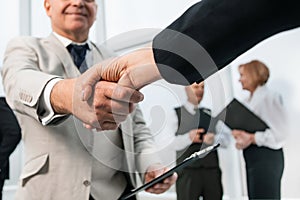 Businessman confidently shaking hands with his business partner.