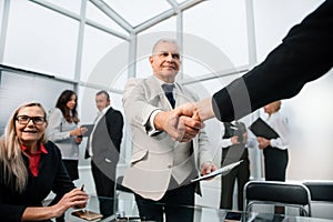 Businessman confidently shaking hands with his business partner.