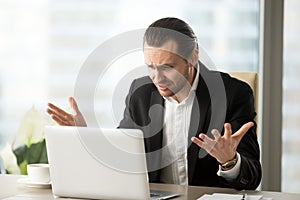 Businessman confused with laptop glitch or bug