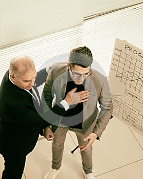 Businessman congratulating an employee on a successful presentation