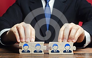 Businessman connects puzzles of workers employees into a single whole. Create effective specialists team for work on a new project