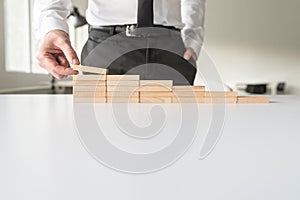 Businessman constructing steps