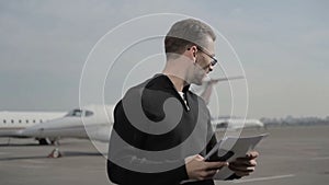 Businessman controls the airplanes dispatch from the airport