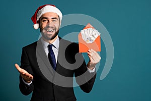 Businessman in corporate suit with tie holding dollars money envelope