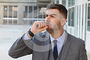 Businessman coughing in office space