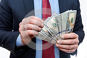 Businessman counting dollar banknotes  on white