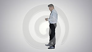 Businessman is counting money on gradient background.