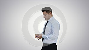 Businessman is counting money on gradient background.