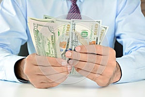 Businessman counting money,US dollar (USD) banknotes photo