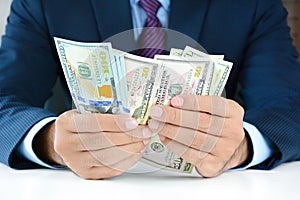 Businessman counting money,US dollar (USD) bills