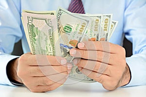 Businessman counting money,US dollar (USD) bills photo