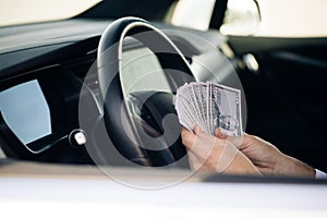 Businessman Counting Money Usd Bills Payday Inside Car. Man sitting with cash money at vehicle