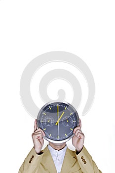 Businessman covering his face with a clock. Conceptual image shot