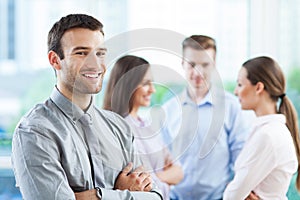 Businessman with coworkers in background photo