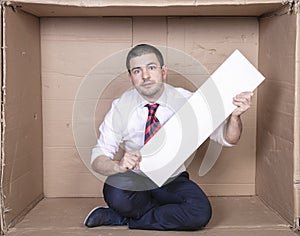 Businessman in a cramped office with copy space in his hands