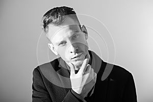 Businessman with crossed arms pose against grey background