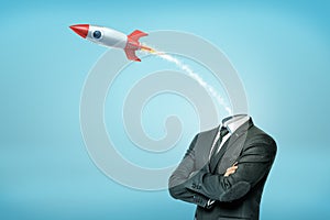 A businessman with crossed arms and with a small launched old-school rocket instead of his head.