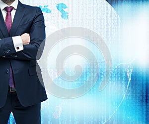 Businessman with crossed hands. Digital world with binary code on the background.