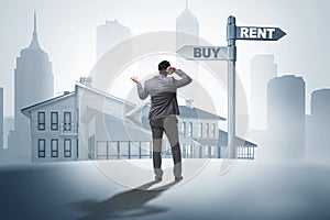 The businessman at crossroads betweem buying and renting