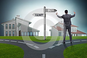 The businessman at crossroads betweem buying and renting