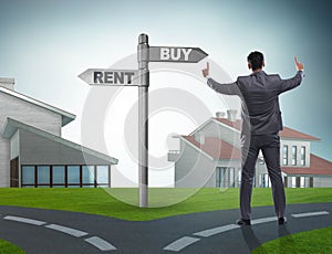 Businessman at crossroads betweem buying and renting