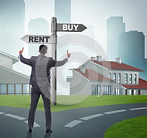 Businessman at crossroads betweem buying and renting