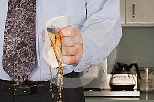 Businessman crushing coffee cup