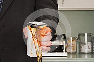 Businessman crushing coffee cup