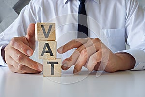 Businessman with cubes VAT or Value Added Tax. photo