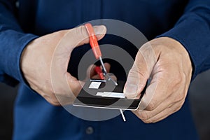 Businessman cutting credit card, bankruptcy concept. Closeup of the hands of a businessman cutting a credit card